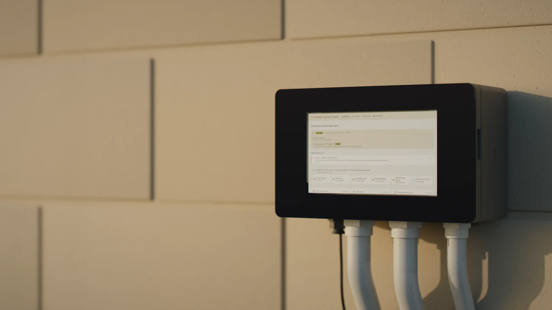 A Droughtless One on a block wall in low evening sun. Its touchscreen shows Controlling, an alert that Practice Green got no water, and last night's check: the soil responded on 4 of 5 runs, every zone but Practice Green.