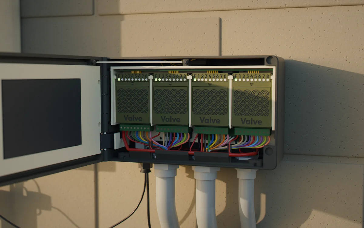 A Droughtless One on a block wall with its door open: four Valve cartridges, each with lit status lights, and color-coded field wiring running down into conduit.